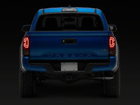 Raxiom 16-23 Toyota Tacoma XW Series Sequential LED Tail Lights- Black Housing- Red Lens